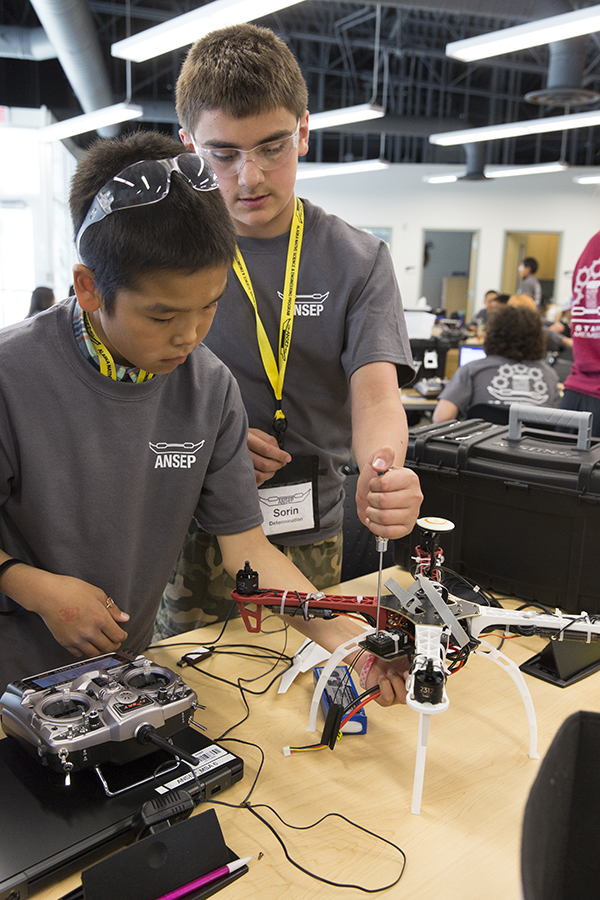 Marcus Hale (L) and Sorin Sorensen (R), put finishing touches on their Unmanned Aerial Vehicle at ANSEP’s STEM Career Explorations in June 2015