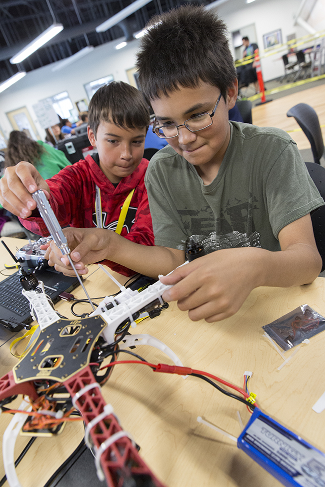 James Lamping (L) and Jakob Andreanoff (R) assemble their Unmanned Aerial Vehicle during ANSEP’s STEM Career Explorations June 2015