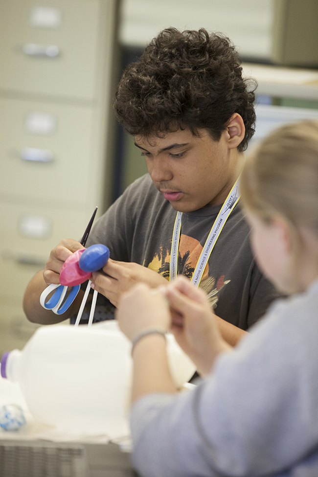 Garrett Cooper assembles model lungs at ANSEP’s STEM Career Explorations in July 2015